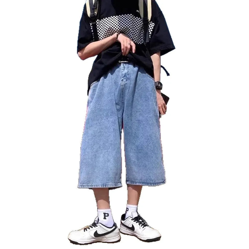 Men's blue washed denim shorts with high waist, cropped length, and straight-leg design on a model