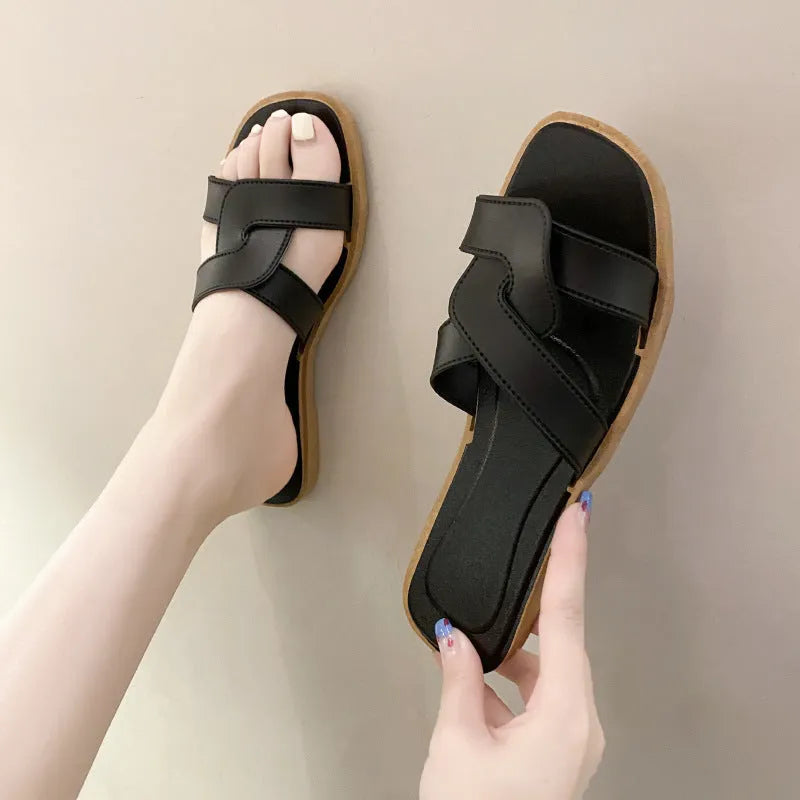 Women's PVC cross strap toe ring flip flops in light blue on a white background.