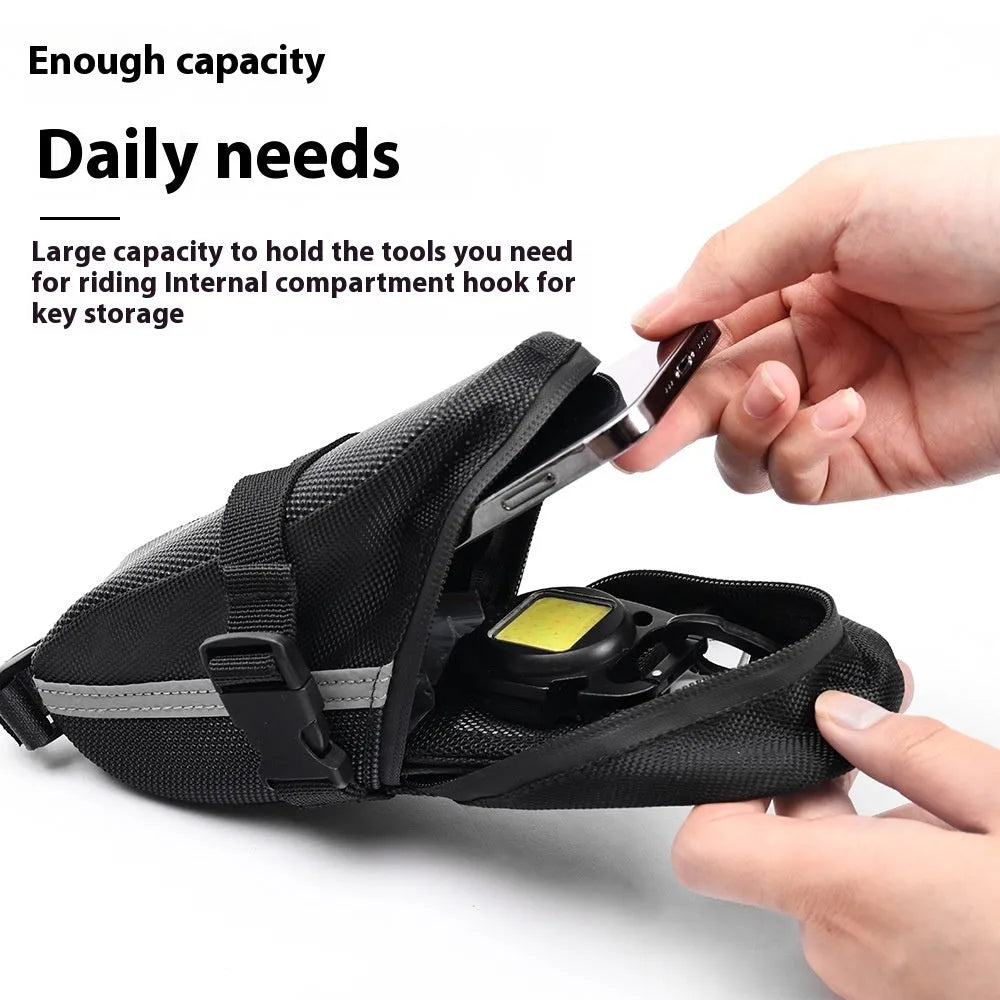 Black cycling quick release saddle bag with polyester construction mounted under bicycle saddle
