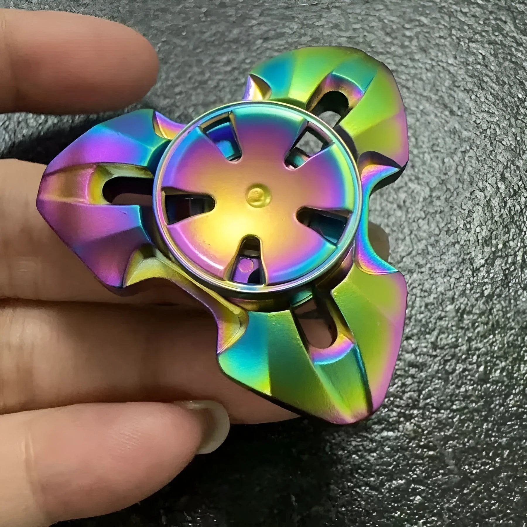 Alloy metal decompression rotating fingertip gyro toy in gun colour and colourful options on a solid background.