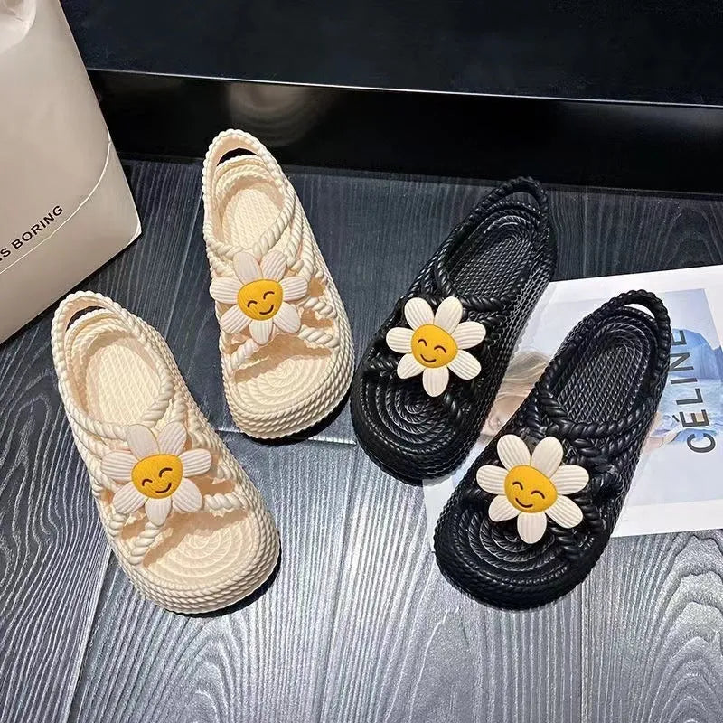 PVC round-toe sandals with a non-slip sole in beige colour with a sunflower decoration.