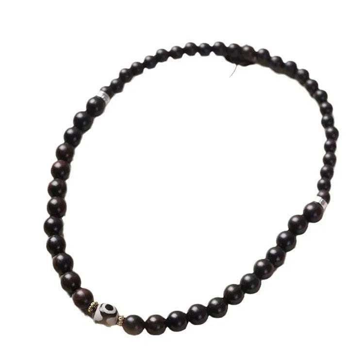 Solid ebony wood Tibetan bead bracelet with two circular 8mm beads on wrist
