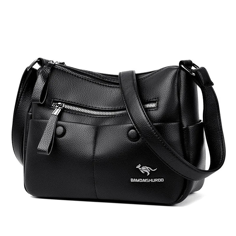 Women's soft leather crossbody bag in horizontal square shape with stitching details and crossbody strap