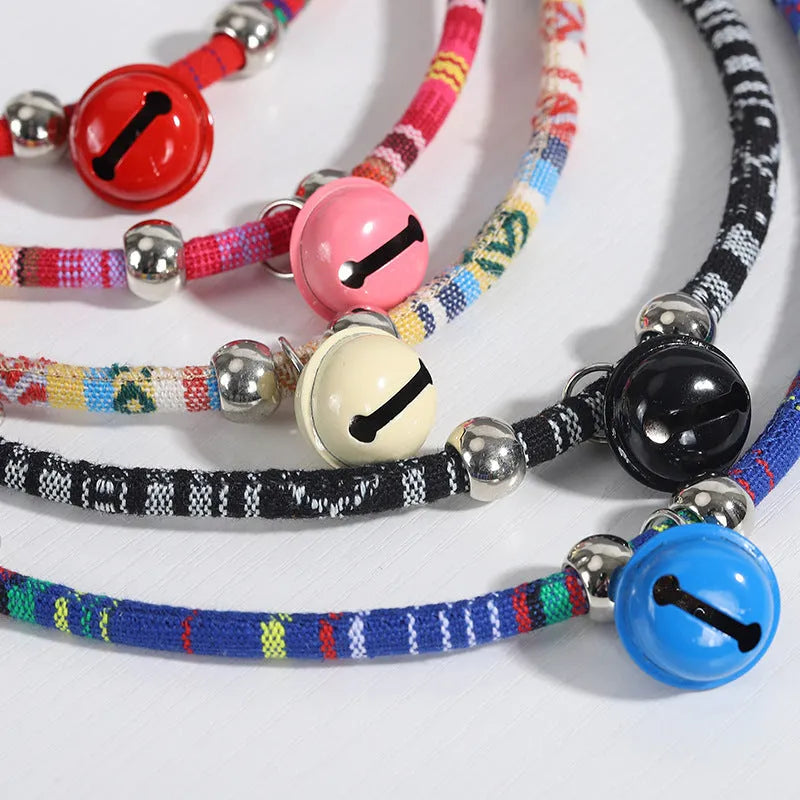 Adjustable dog collar with ethnic patterns and bell in black, blue, pink, red, or white colours, sizes S and L