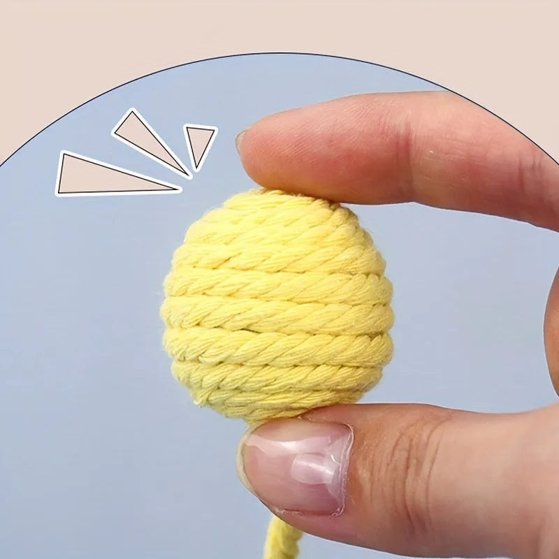 Colourful cat toy ball with attached rope and internal bell mechanism in green, pink, purple, or yellow options