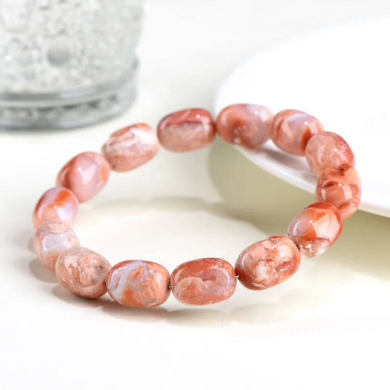 Natural cherry agate barrel shaped bead bracelet showing 10x14mm geometry design with Ruyi elements on wrist