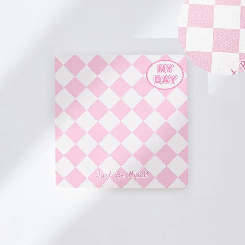 Manual ledger notebook with 100 sheets showing 12 different cover designs including checkerboard and fruit patterns