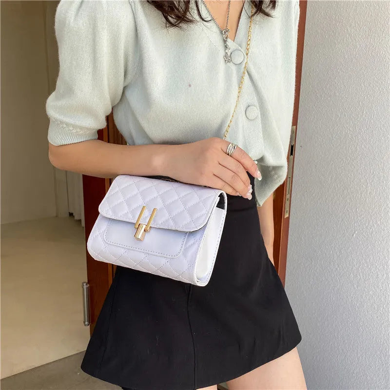 Women's crossbody bag with diamond lattice pattern, adjustable 120cm strap, shown in black colour with dimensions 17.5cm width