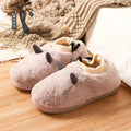 USB foot warmer electric heating shoes in black colour with velvet upper and plastic sole, showing USB cable connection