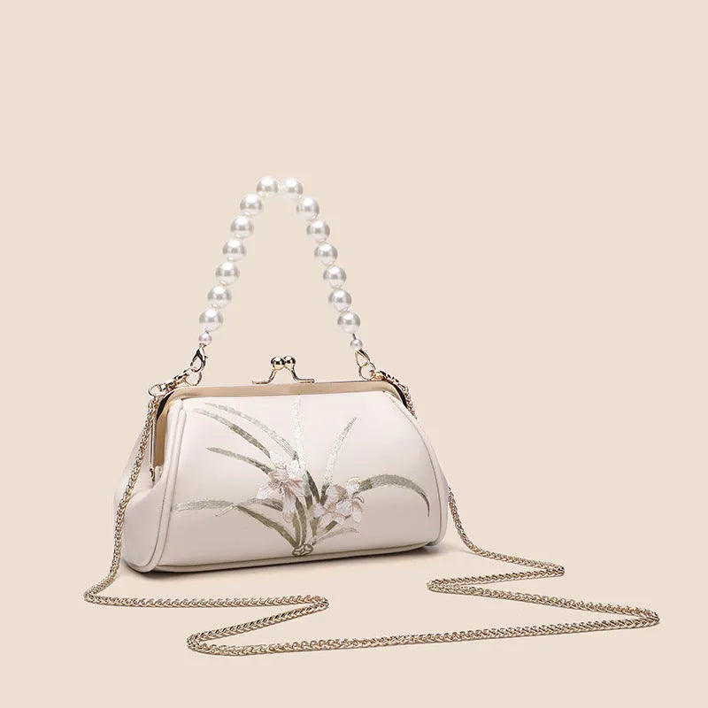 Beige women's embroidered shoulder bag with shell shape design in soft PU material