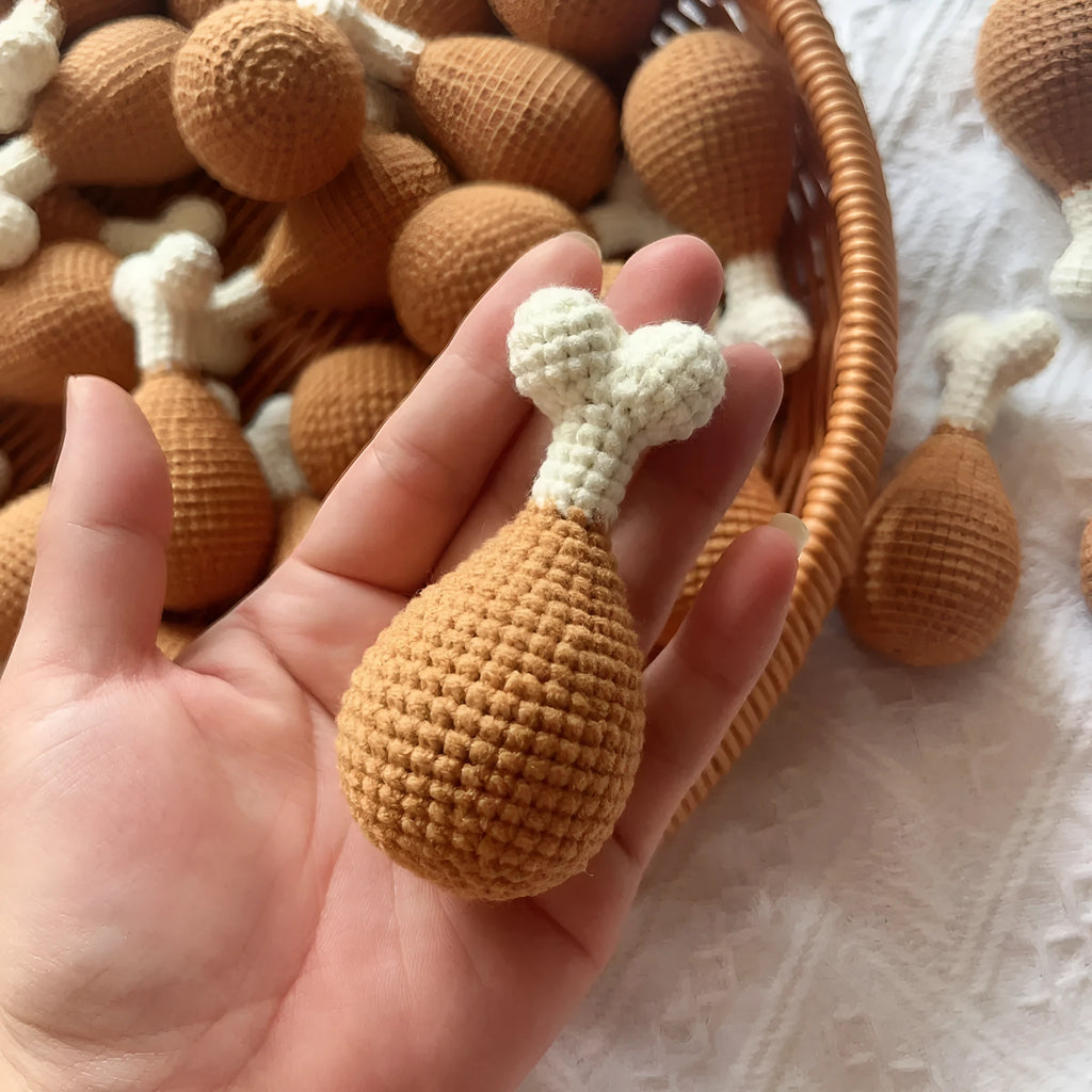 Hand-crocheted beige chicken leg keychain made from soft plush yarn on a metal ring.