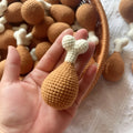 Hand-crocheted beige chicken leg keychain made from soft plush yarn on a metal ring.