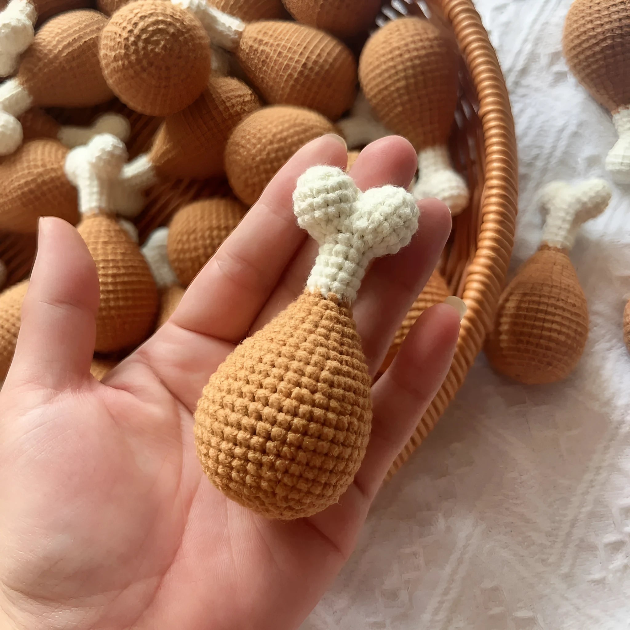 Hand-crocheted beige chicken leg keychain made from soft plush yarn on a metal ring.