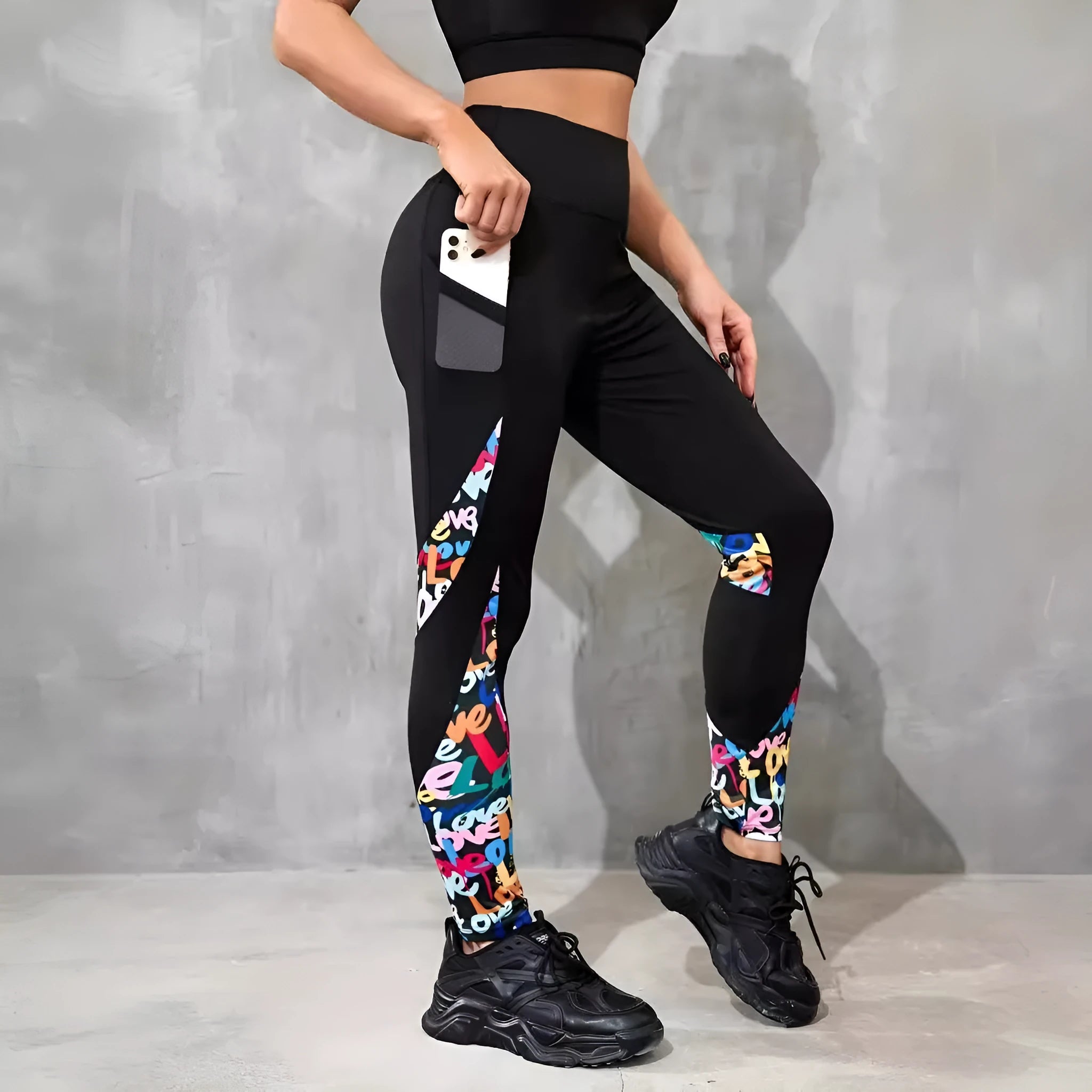 Women's black polyester yoga leggings with side pocket and leopard print pattern detail