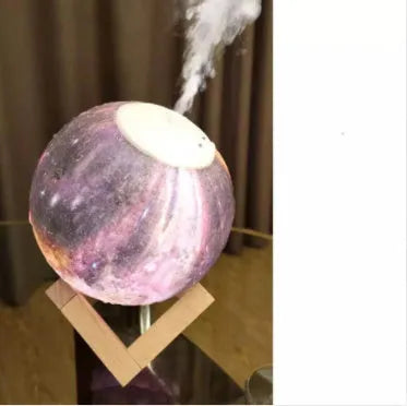 Spherical white lunar humidifier and night light with USB charging port and soft LED glow.