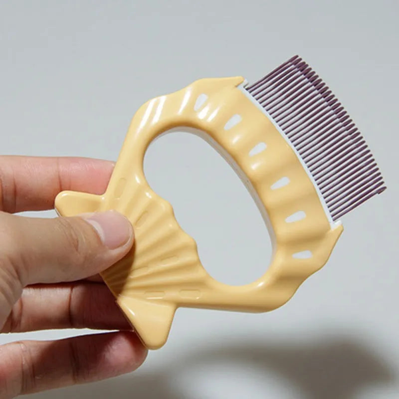 Shell-shaped pet grooming brush in green, orange, or purple with bent wire bristles and anti-slip handle