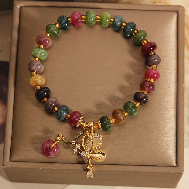 Colourful women's alloy bracelet with multicoloured beads and a butterfly charm on a wrist.