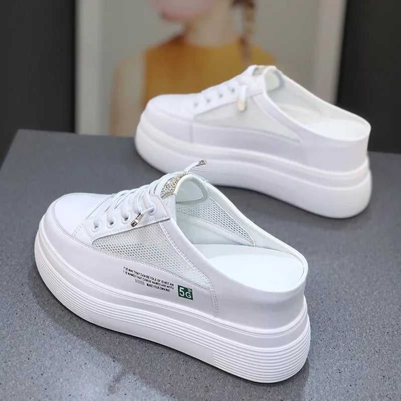 White women's platform shoes with mesh detail and a round toe on a rubber sole.