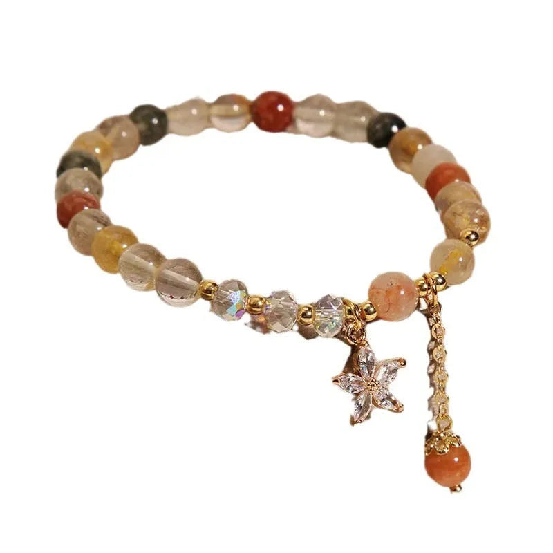 Colour hair crystal cat's paw charm bracelet with zircon butterfly on wrist.