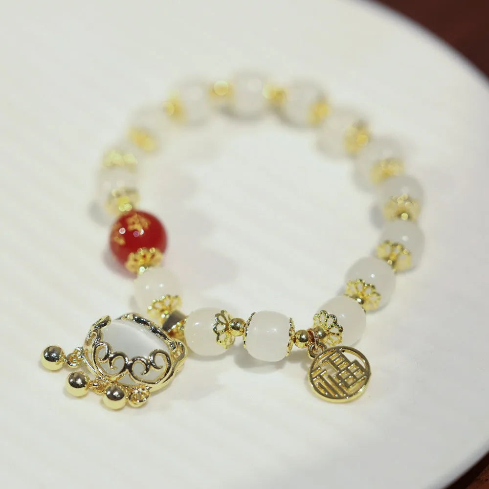 Chinese style coloured glaze bracelet with glass safety lock charms and windmill bead design