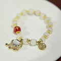 Chinese style coloured glaze bracelet with glass safety lock charms and windmill bead design