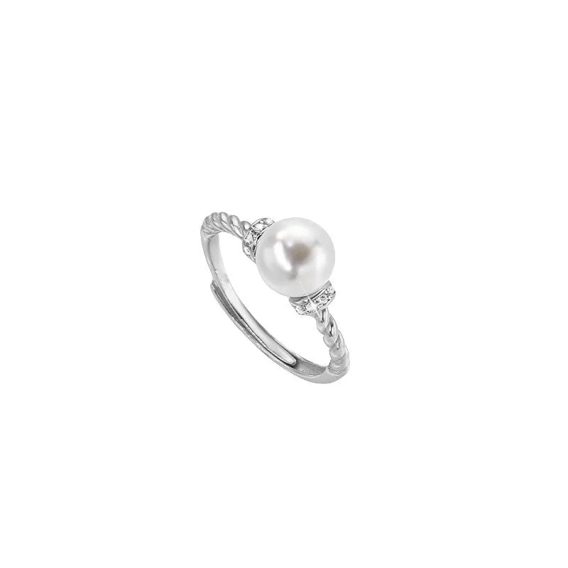 Adjustable copper ring with geometric pearl inlay in antique twist pattern, showing gold and silver finish options