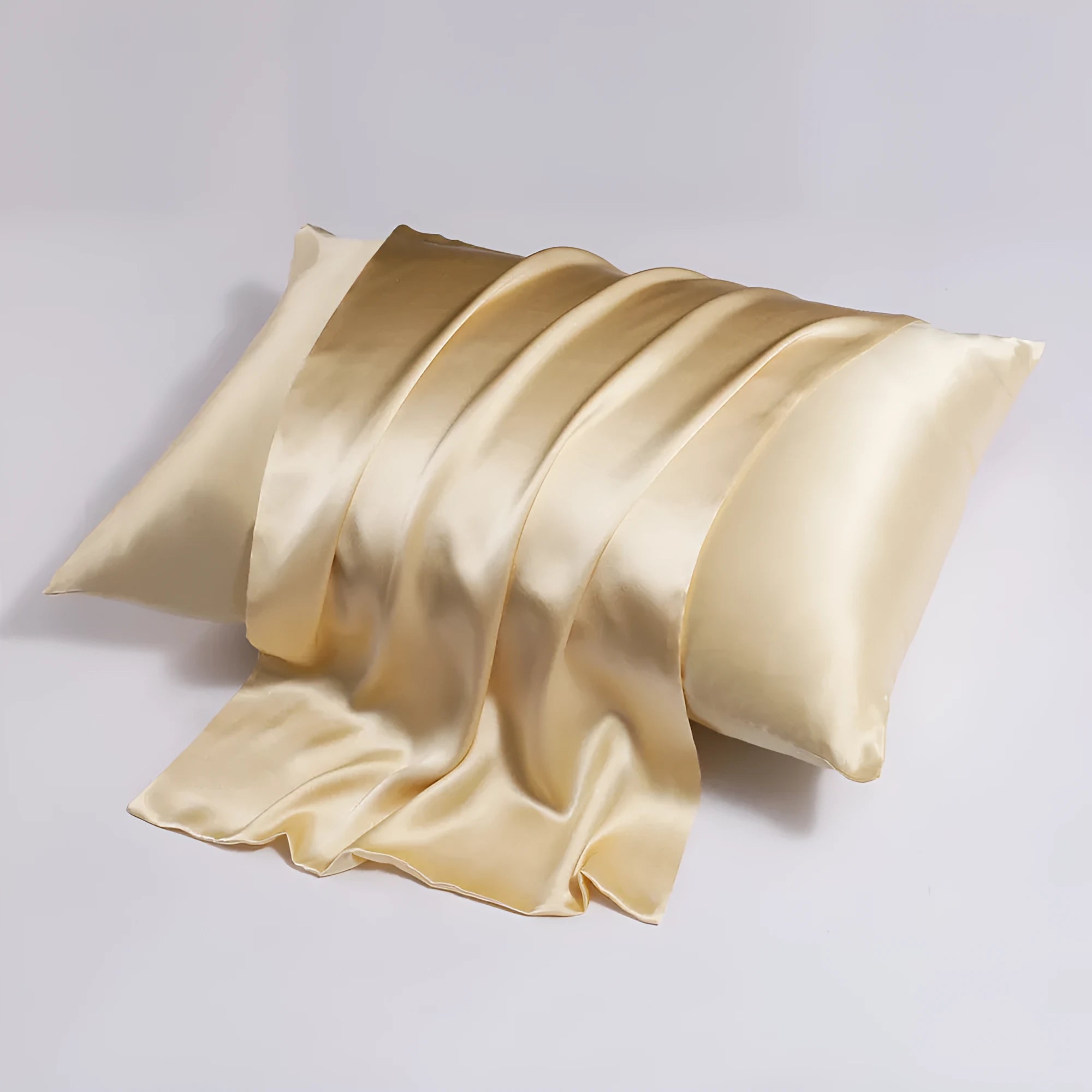 Close-up of a navy blue silk pillowcase showing a discreet zipper closure along the seam.