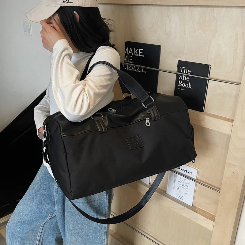 Large black Oxford cloth messenger bag showing its size and style.