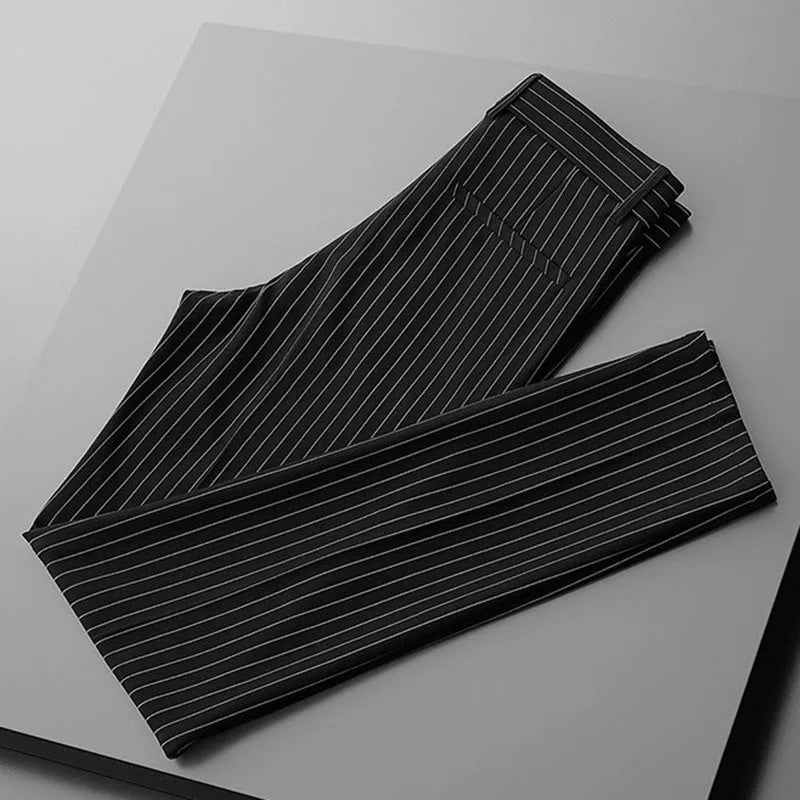 Man wearing loose fit thin striped suit pants in a crop jeans style, available in black or white.