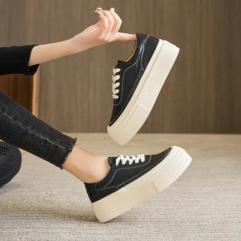 Women's black embossed cowhide leather platform sports shoes with white rubber sole and lace-up front.