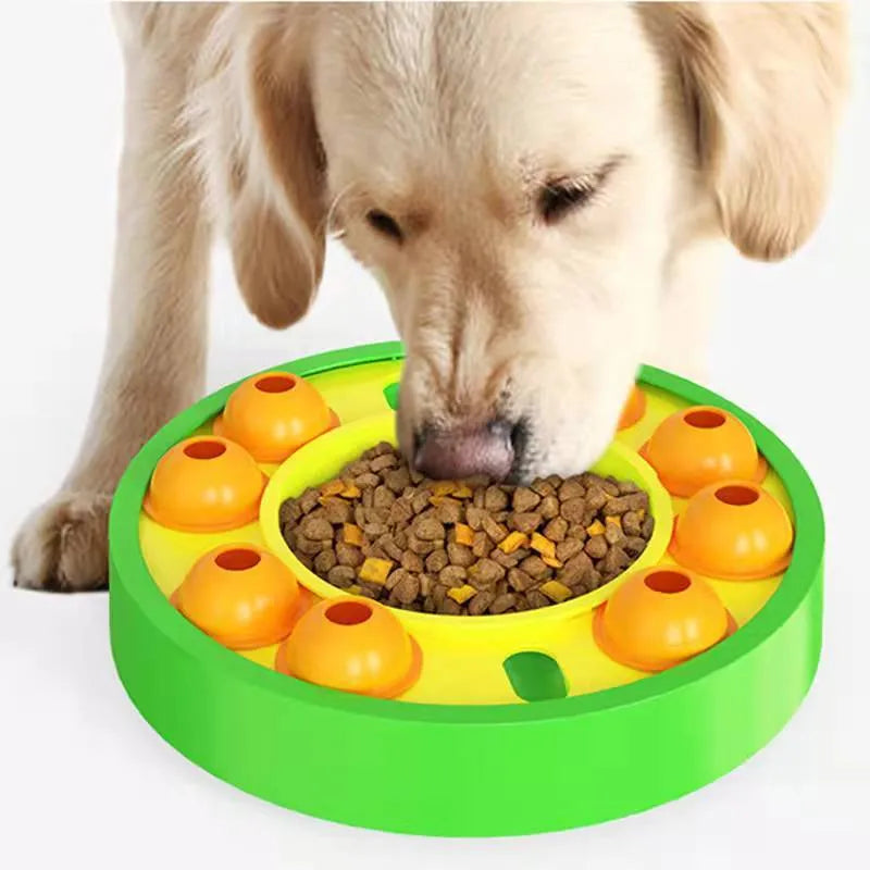 Square green interactive dog puzzle feeder bowl with central column and top turntable on a non-slip base.