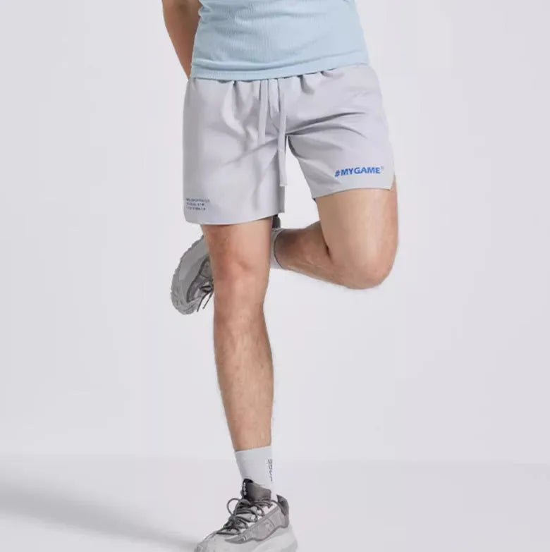 Men's midnight blue training fitness shorts with moisture-wicking fabric on a gym background.
