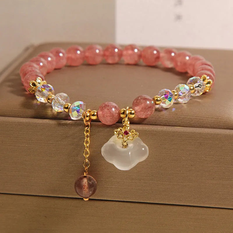Women's strawberry quartz and white agate crystal bracelet with auspicious clouds charm.