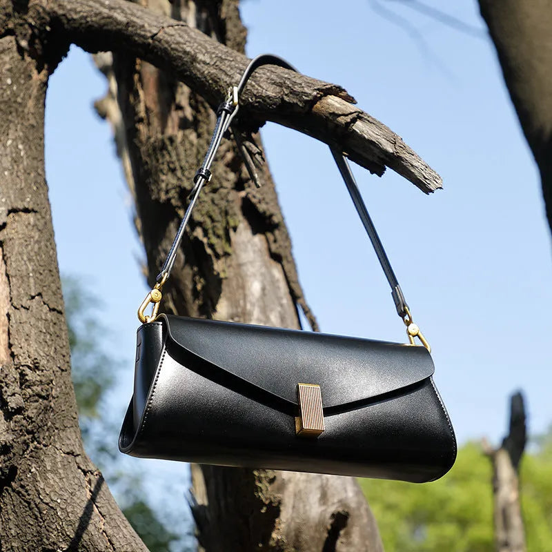 Milky white cowhide leather women's crossbody bag showing clamshell opening and pillow shape.