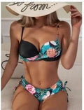 Green two-piece push-up bikini with drawstring printed bottoms laid flat.