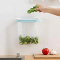 Blue plastic kitchen garbage bag storage rack on a cabinet shelf