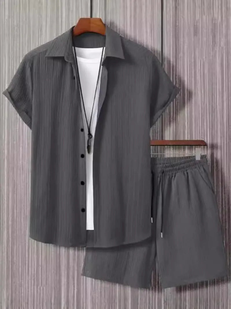 Man wearing a beige jacquard short sleeve suit jacket and matching shorts on a summer day.