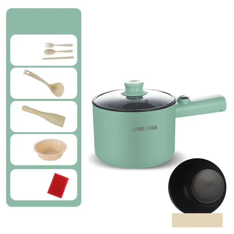 White and green mini electric hot pot cooker with stainless steel body and cooking accessories on a kitchen counter.