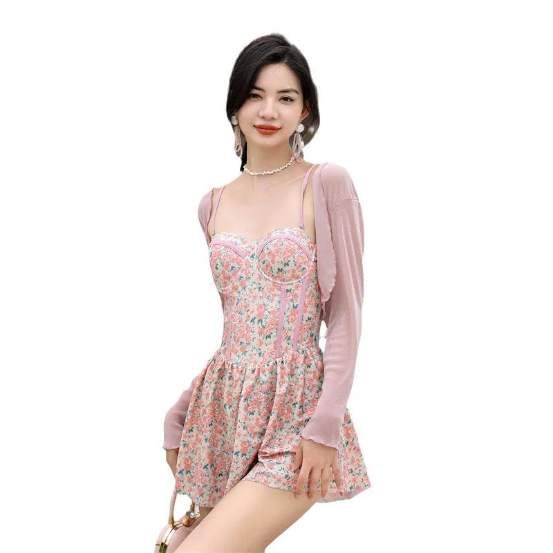 Women's floral one-piece swimsuit with suspender straps in green and pink colour options