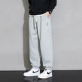 Men's loose grey cotton sports trousers with elastic waistband on hanger