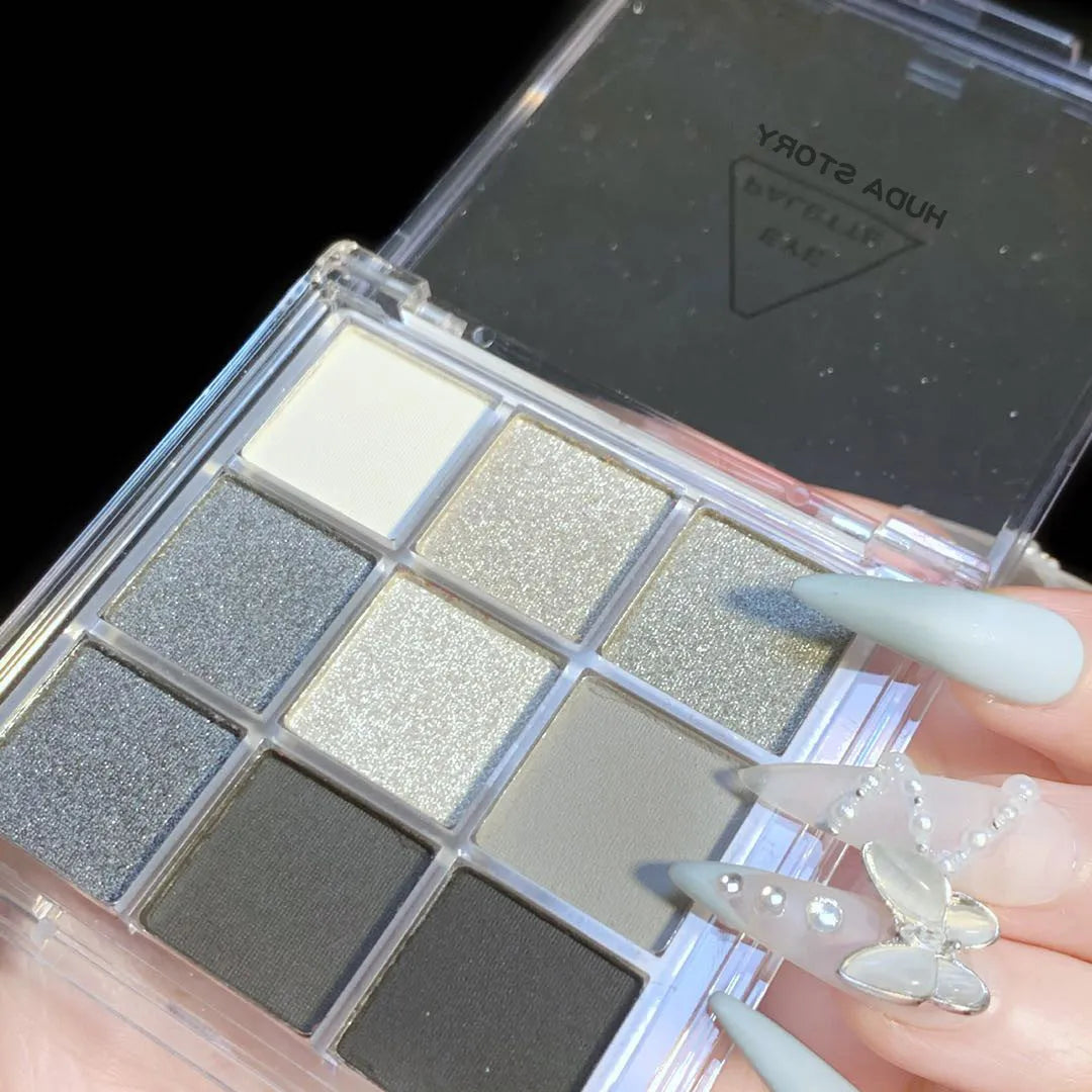 Smoked nine-colour eye shadow palette showing shades including white, silver, black, and iron grey.