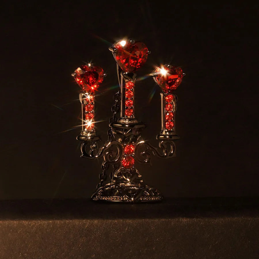 A women's gothic-style necklace with a hollow candlestick pendant on a cross chain, in a retro candlestick colour.