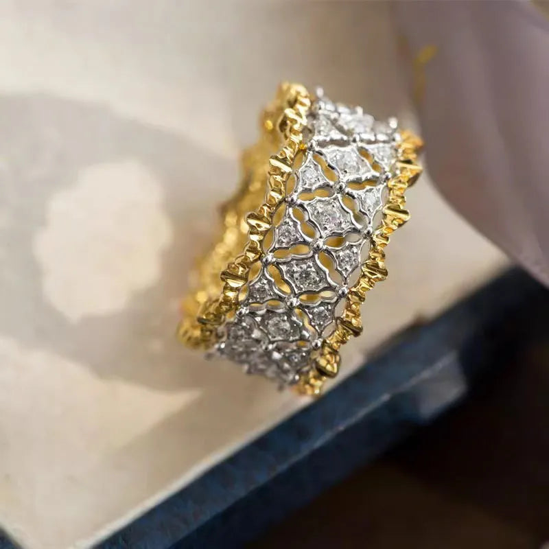 Geometric two-tone zircon ring on finger showing copper construction with electroplated finish and round stone