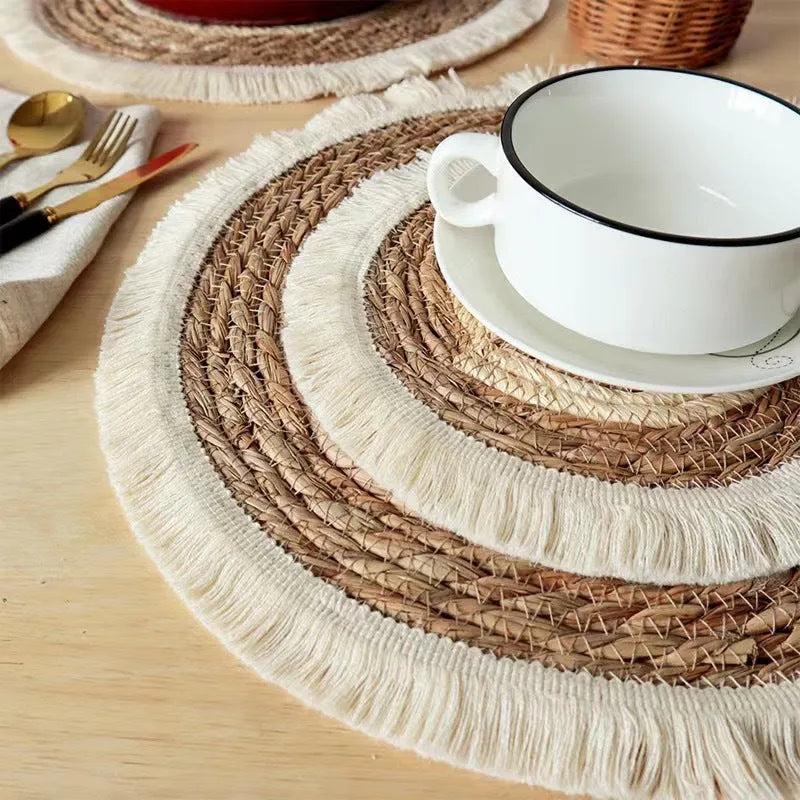 Round Japanese straw placemat with decorative tassels in natural papyrus colour, showing handwoven texture