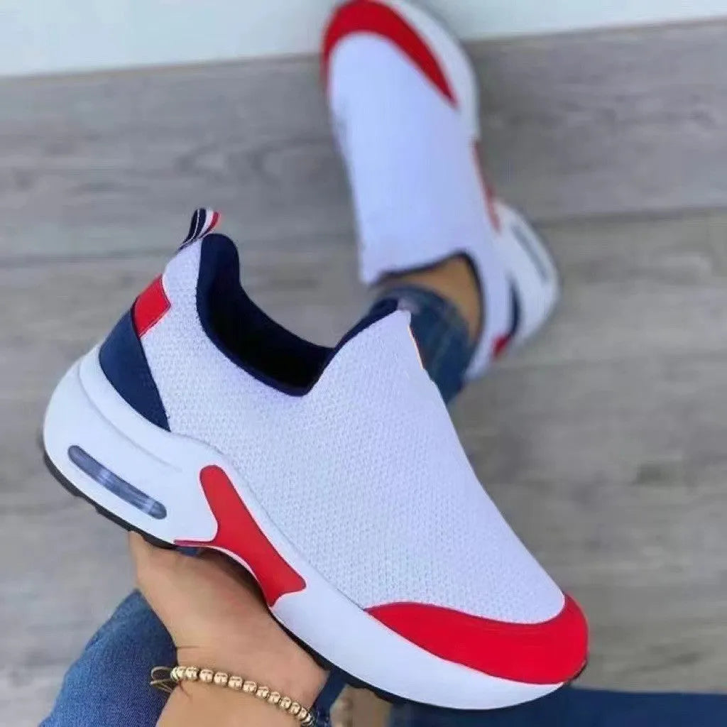 Women's knit sneakers with round toe, flat heel and rubber sole, shown in black, red, white and navy blue.