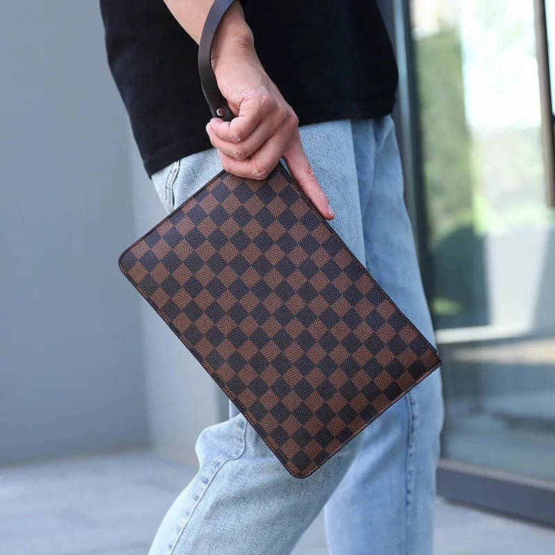 Men's black PU leather clutch with six card slots, measuring 18cm by 28cm, on a table