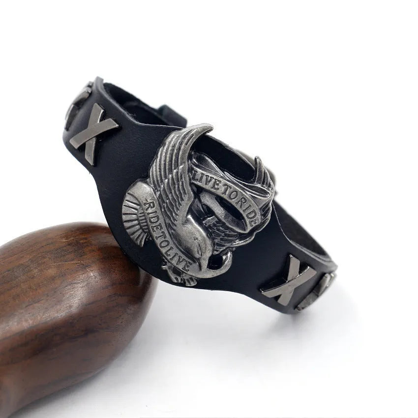 Black geometric leather bracelet with alloy eagle watch-button closure, showing 26cm length and 1.7-3.8cm width variation