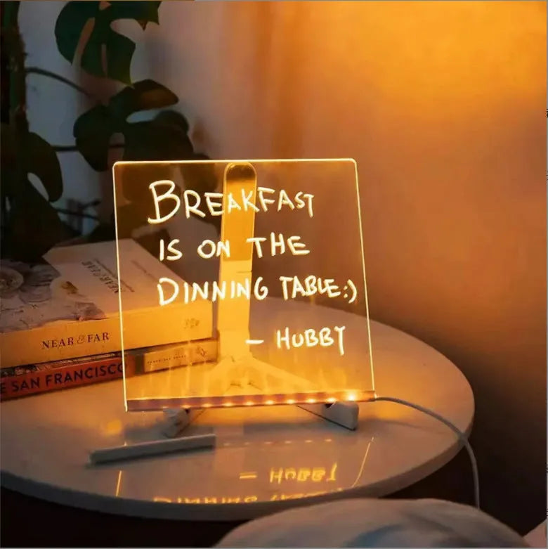 Acrylic DIY LED message board night light on a desk with handwritten drawing glowing softly.