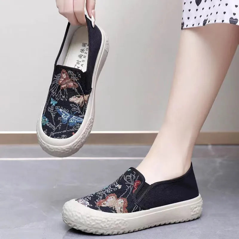 Women's black and white canvas slip-on shoes with round toe and decorative sewing thread details
