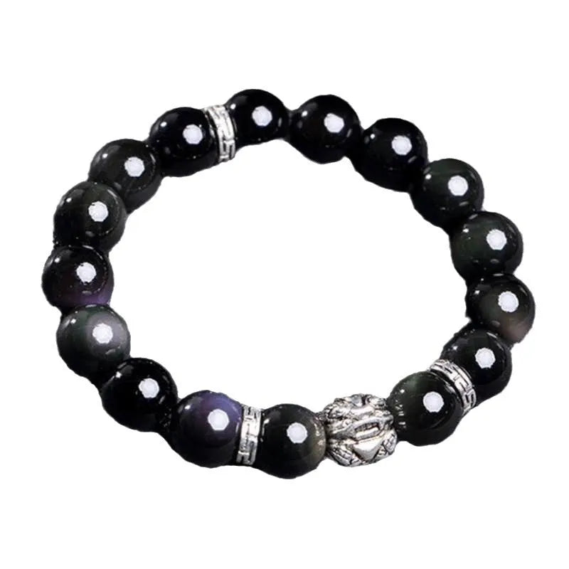 Natural obsidian and 999 silver unisex bracelet on a wrist, showing 10mm or 12mm bead size options.